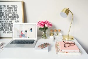 Web design Content on laptop with a golden lamp and a pair of glasses